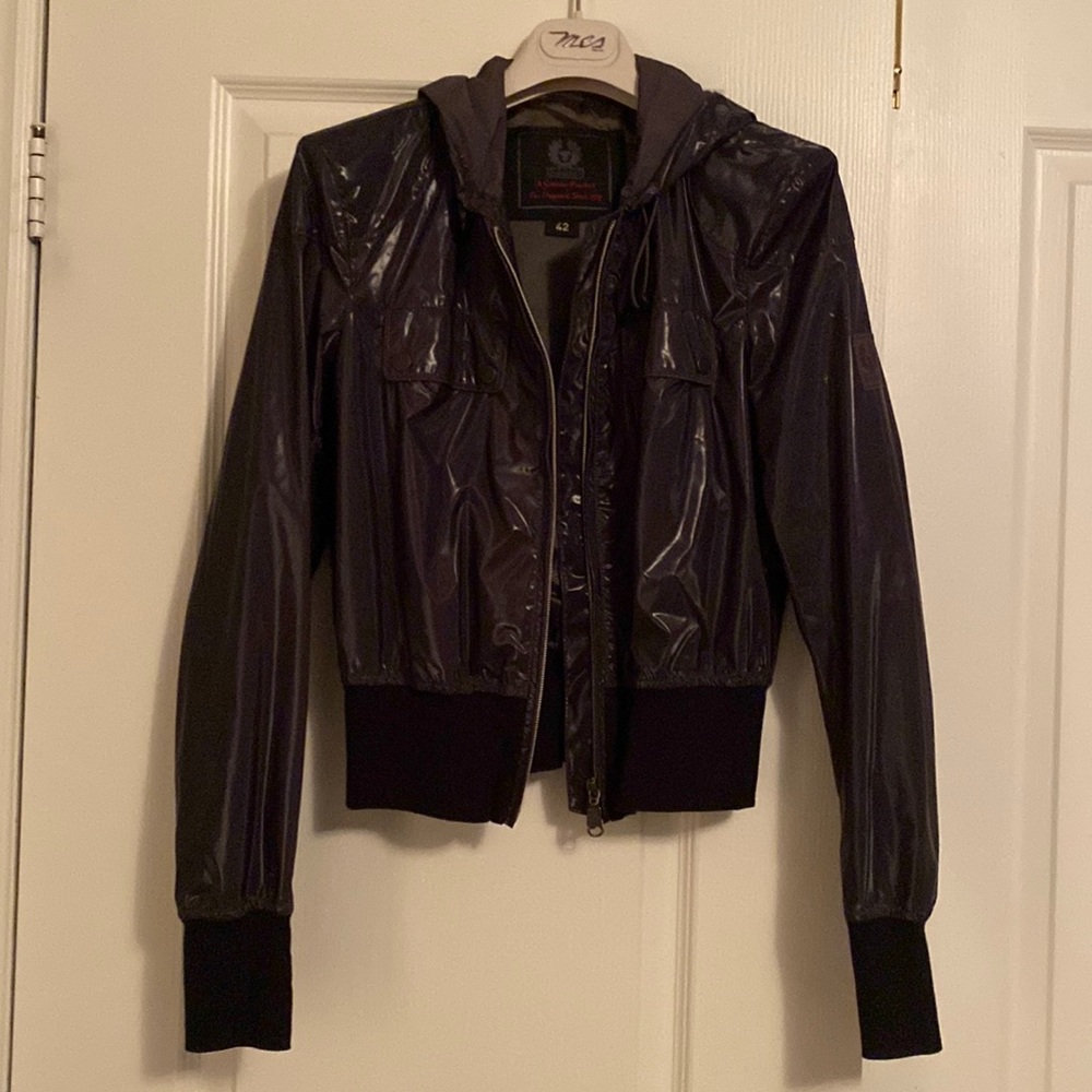 Women’s cropped bomber jacket. Shiny material. Looks blackish/grey. It is lined.